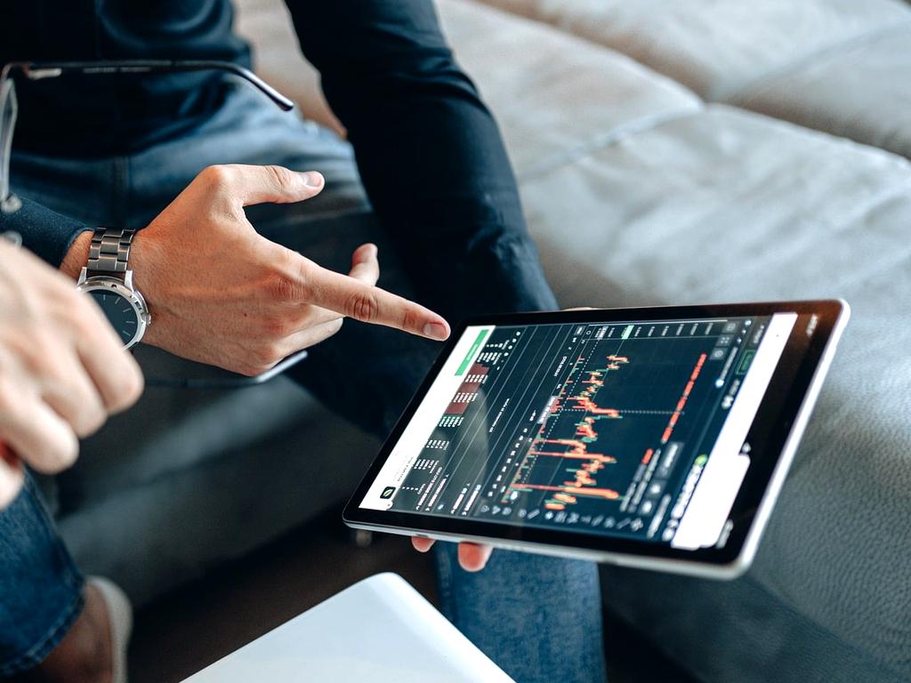 Financial advisor using a tablet to show debt reduction charts